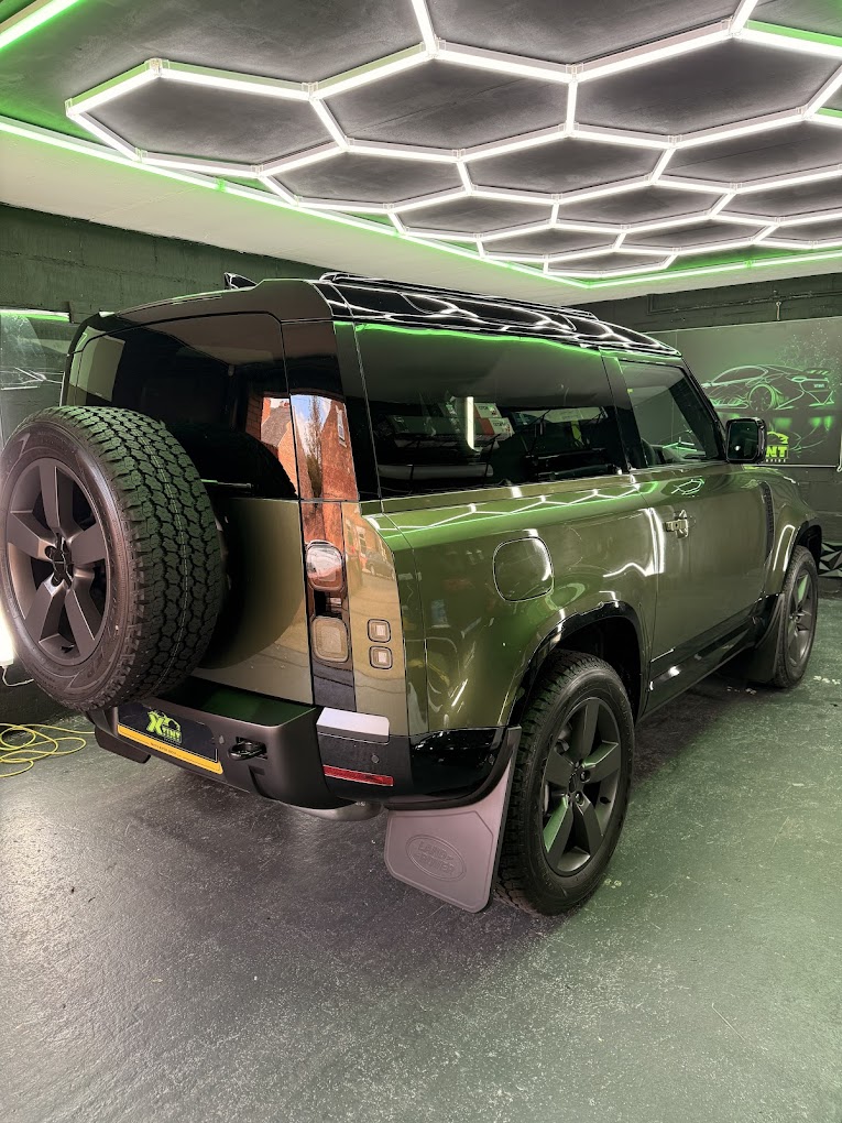 Green Land Rover Defender tinted in the XTINT studio