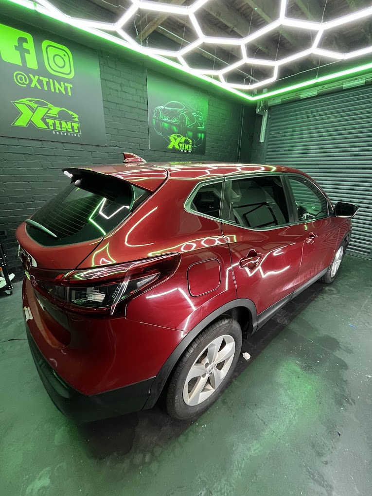 Red Nissan Qashqai freshly tinted in the XTINT studio
