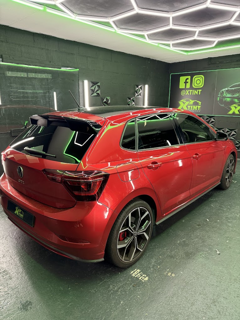 Red Volkswagen Polo GTI with smoked rear tint in the XTINT studio